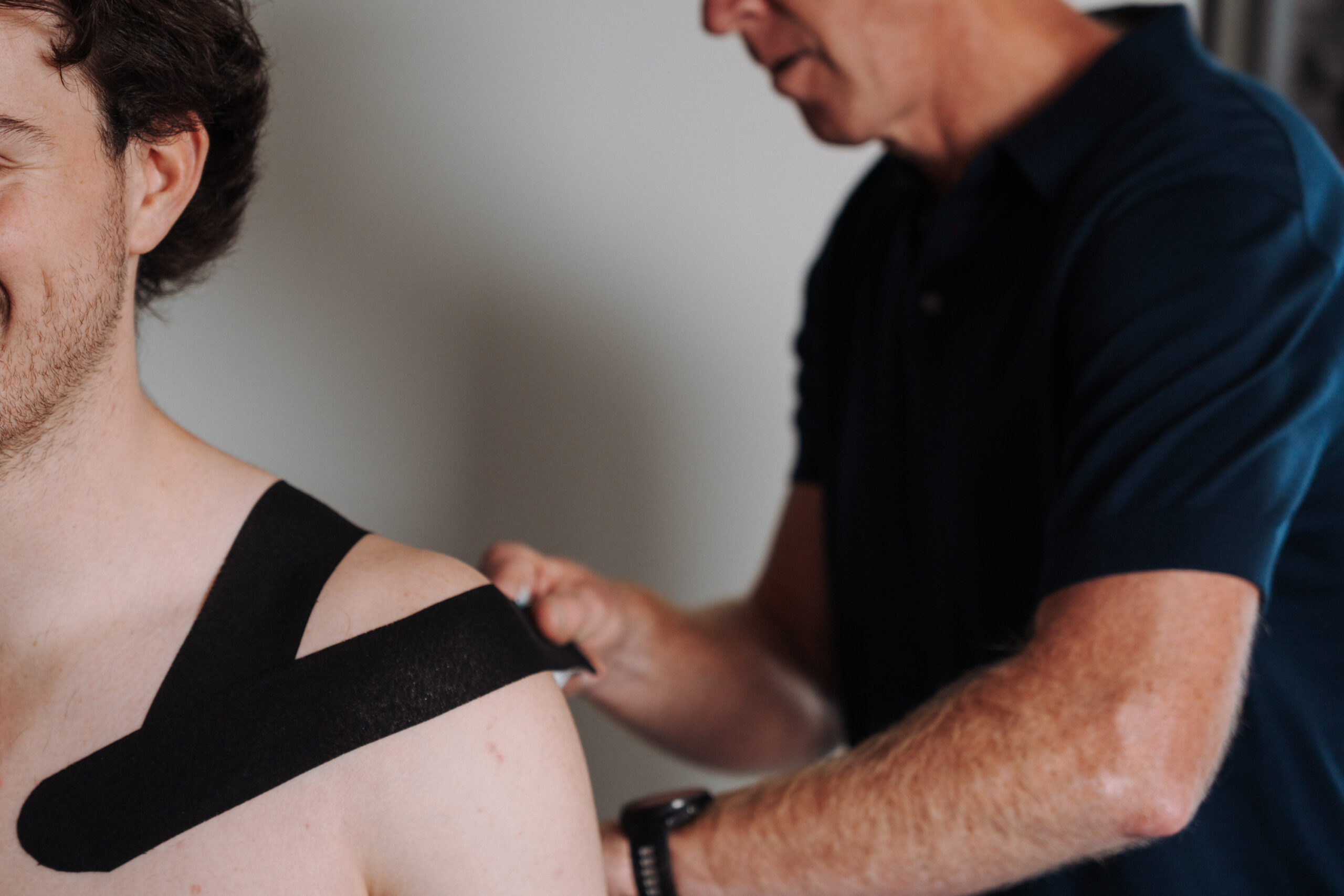 Man having his shoulder strapped by physio. Ballarat Sports Physiotherapy